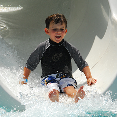 boy going down slide