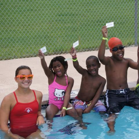 lifeguard and children in a pool